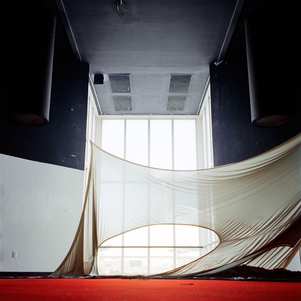 decorative colour photograph of a sagging drape in an abandoned space